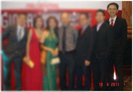 Ka Hoe in a suit at an event with a group, in a photo dated 2011